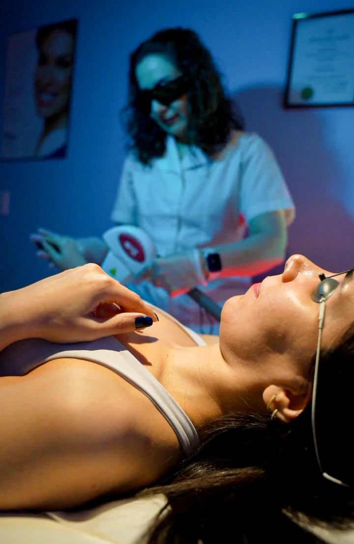Ghazaleh performing a laser treatment while the client wears protective eyewear